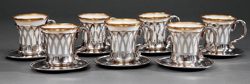 Sterling Silver Demitasse Cup Frames and Saucers: Seven Sterling Silver Demitasse Cup Frames and Saucers , 20th c., silver marked for Webster & Co., porcelain liners with gilt rims, cup h. 1 1/2 in., w. 2 in., d. 1 1/2 in., saucer dia. 2 1/2 in IMPOR