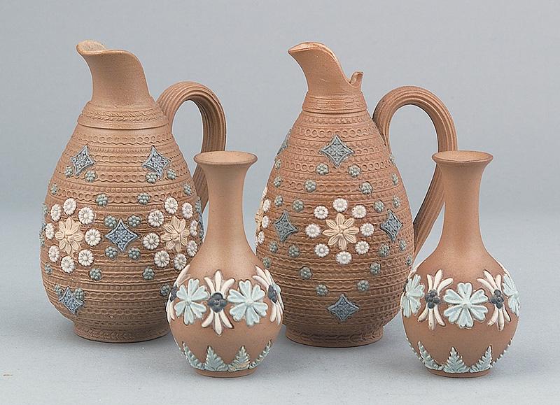 Doulton Lambeth Stoneware Decorative Objects: Two Pairs of Doulton Lambeth Stoneware Decorative Objects , c. 1915, incl. 2 small jugs and 2 vases, all decorated with applied floral designs in tan, green, white and blue against a brown ground, jug