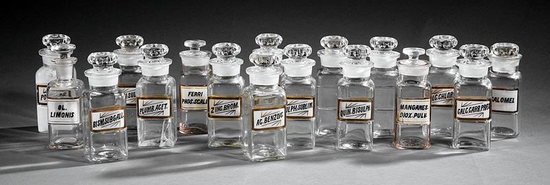 Seventeen American Apothecary Jars: Seventeen Antique American Apothecary Jars with Stoppers , reverse painted glass labels with gilt edges, bottle h. 4 1/2 in IMPORTANT: All purchases must be removed from our premises within 15 days of