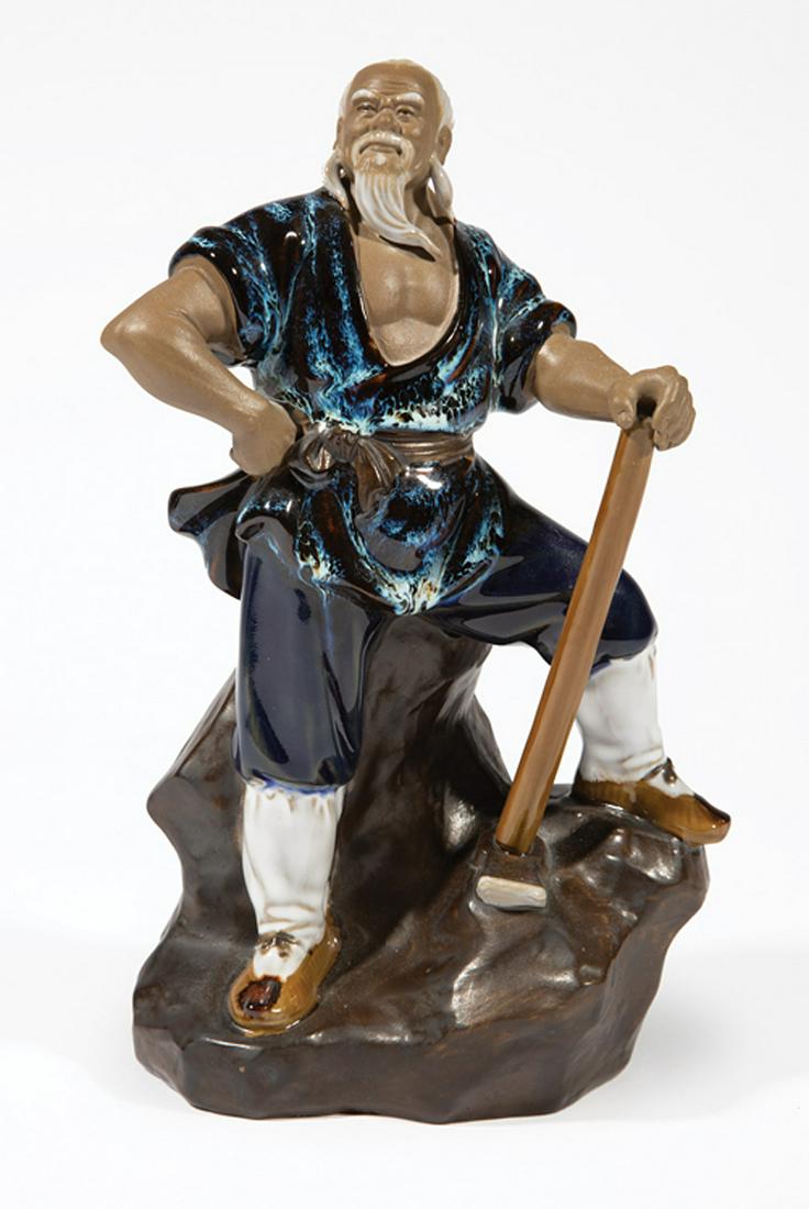 Chinese Shiwan Glazed and Biscuit of a Farmer: Chinese Shiwan Glazed and Biscuit Figure of a Farmer , 20th c., modeled standing on a rock grasping a hoe, h. 9 1/2 in., w. 6 in . Provenance: Estate of Stephen G. Henry, Jr., Baton Rouge, LA. Conditi