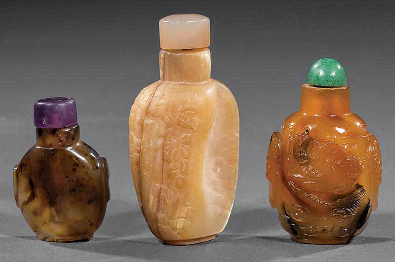 Three Chinese Snuff Bottles: Three Chinese Snuff Bottles , stoppers, incl. two glass imitating agate, h. 1 7/8 in. and 2 3/8 in.; and mother-of-pearl, carved with a Buddhist lion, h. 2 7/8 in . Provenance: The Sturm Collection, S