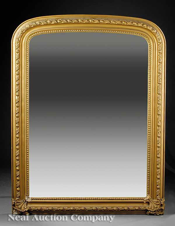 American Carved Giltwood Overmantel Mirror: An Antique American Carved Giltwood Overmantel Mirror, mid-19th c., arched molded frame with seedpod and ribbon molding, beaded inner molding, fan carved corners at the base, height 59 1/2 in., width
