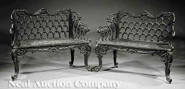 Pair of American Rococo Cast Iron Settees: A Pair of American Rococo Cast Iron Settees, mid-19th c., probably New York, after a design introduced by Carron Ironworks, Scotland (1759-1982), scrolled foliate crests, interlocking arched latticewo