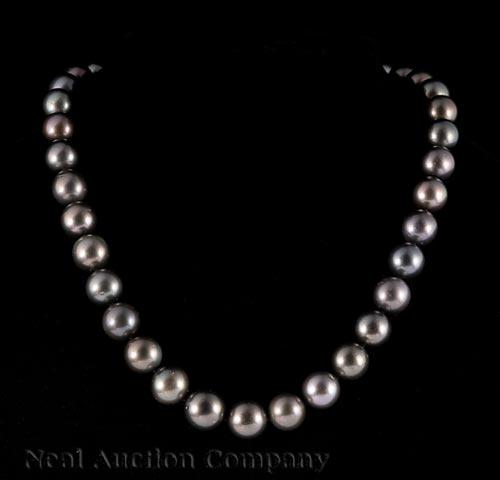 Tahitian Pearl Necklace: Tahitian Pearl Necklace , 37 graduated round cultured pearls, dark gray color with purplish overtones, 11 to 13 mm; 14 kt. white gold bead clasp; l. 18 in., AIGL report * Payment for all jewelry purch