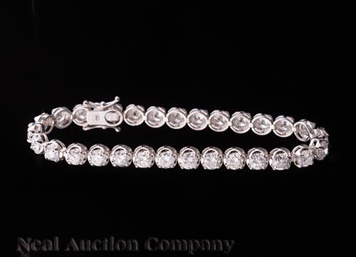 18 kt. White Gold and Diamond Bracelet: 18 kt. White Gold and Diamond Bracelet , 29 prong set round faceted diamonds, total wt. approx. 10.42 cts, l. 7 in. * Payment for all jewelry purchases must be made by cash, check or wire transfer.
