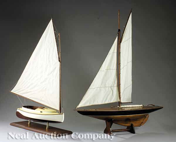 Two Decorative American Ship Models: Two Decorative American Ship Models, 20th c., comprised of a mahogany and painted schooner, outfitted with sails, and a mahogany and composition model of a catboat with gaff ring, both presented on st