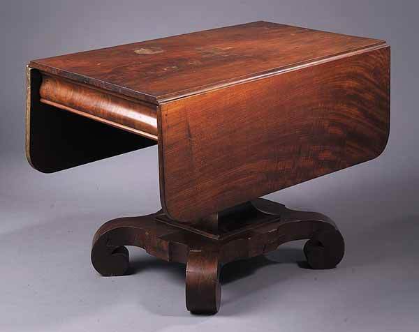 American Late Classical Mahogany Dr: An American Late Classical Mahogany Drop-Leaf Breakfast Table , c. 1830, in the stle of J. & J.W. Meeks, the figured top above an ogee skirt, the flaired pedestal raised on scrolled feet, height 28 in