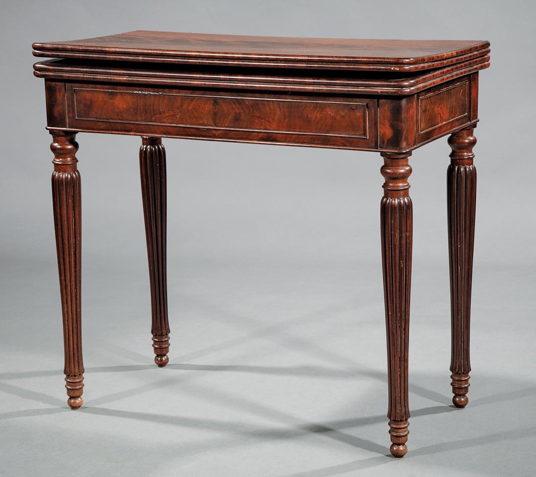Regency-Style Carved Mahogany Games Table: Regency-Style Carved Mahogany Games Table , foldover top with baize-lined playing surface, concertina action, reeded tapered legs, button feet, note: top warped , h. 30 in., w. 32 1/2 in., d. (closed)
