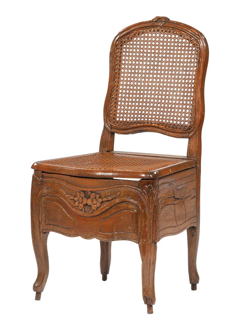 French Provincial Carved Walnut Commode Chair: French Provincial Carved Walnut Commode Chair , 19th c., floral carved crest, caned back, hinged cane seat, deep carved apron, cabriole legs , h. 37 1/4 in., w. 19 3/8 in., d. 16 7/8 in IMPORTANT: All