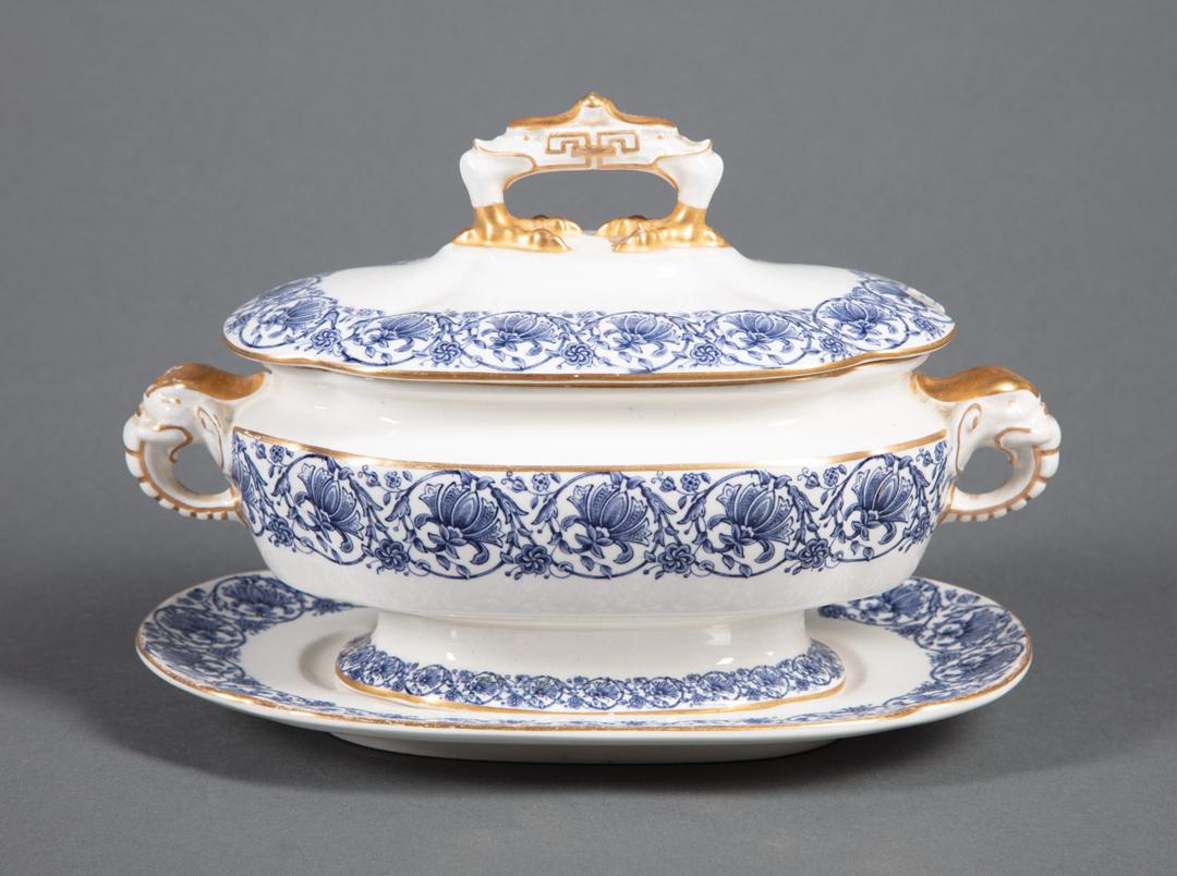 Royal Worcester Porcelain Covered Sauce Tureen: Royal Worcester Blue and Gilt Decorated Porcelain Covered Sauce Tureen , marked, blue elephant form handles, scalloped gilt rimmed underplate, h. 6 1/2 in., w. 8 1/2 in., d. 6 in.; Condition: overall 