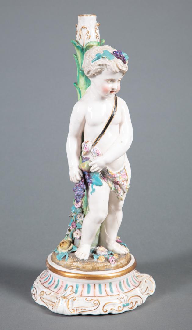 Meissen-Style Porcelain Figural Candleholder: Meissen-Style Polychrome and Gilt Porcelain Figural Candleholder , putto with fruiting grapevine, h. 13 in. Condition: lacking bobeche; restored breaks to both legs of the putto, to the stalk and to t