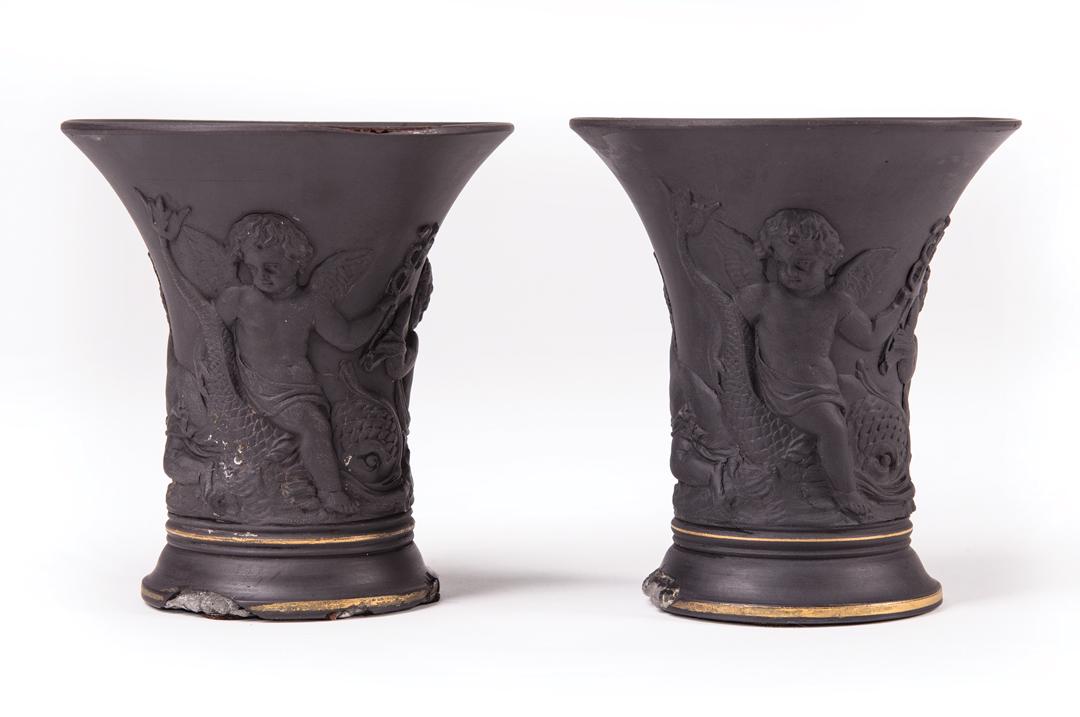 Pair of Black Basalt Spill Vases: Pair of Black Basalt Spill Vases , late 18th/early 19th c., possibly Wedgwood, unmarked, putto and dolphin relief, gilt rim, h. 3 3/4 in., dia. 3 1/2 in. Note: Restoration throughout, losses IMPORTANT