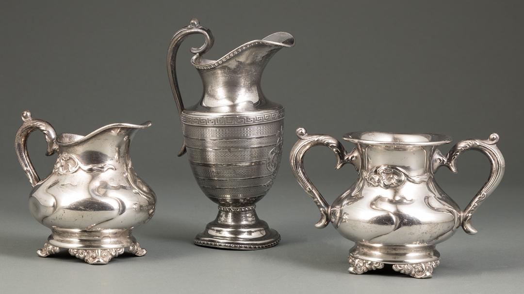 Group of Three Silverplate Table Items: Group of Three Silverplate Table Items , incl. creamer and sugar, marked "Victor Silver Company 2670", h. 4 in.; and pitcher, marked, Greek key motif with monogram, h. 6 1/2 in IMPORTANT: All purchase