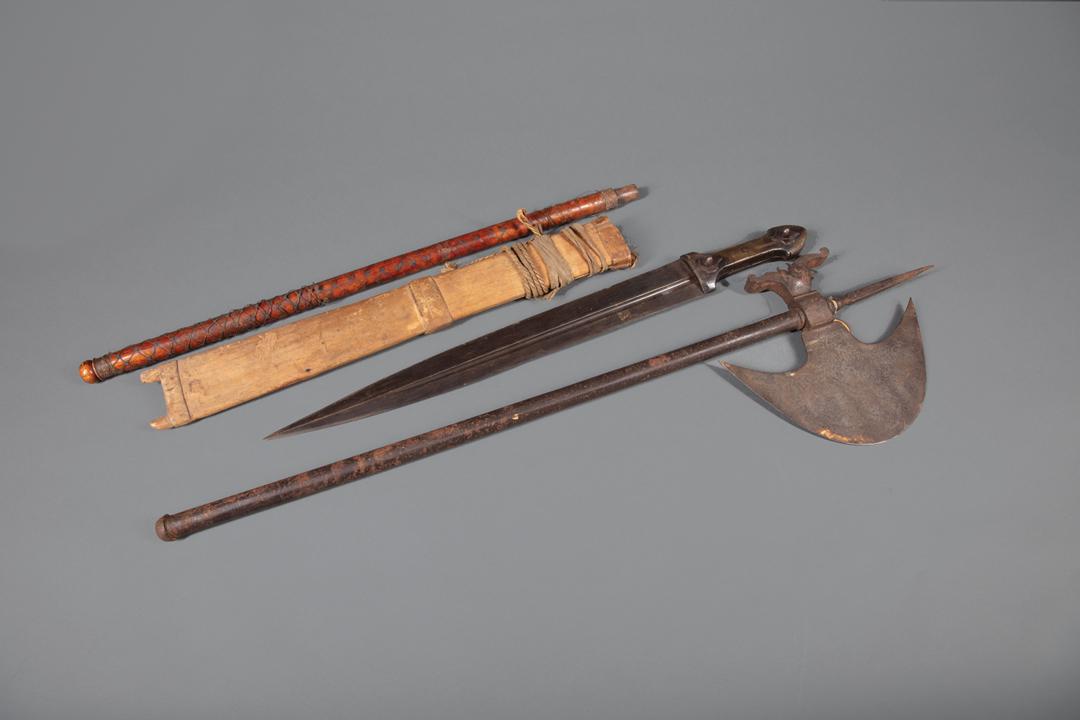 Two Continental Edged Weapon: Two Continental Edged Weapons , 19th c., incl. an incised-decorated halberd, h. 32 in.; and a short sword with bone handle, length 23 in., together with a wood handle for an unknown object Provenance: