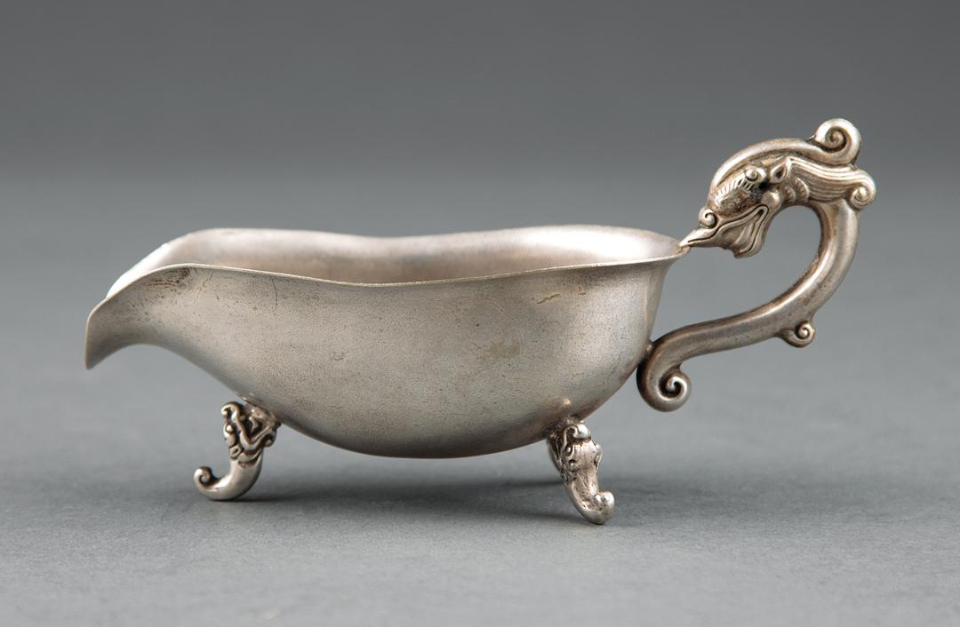 Chinese Paktong Vessel: Chinese Paktong Vessel , 19th c., dragon handle, three dragon mask feet, base with punch marks, h. 2 3/4 in., l. 5 3/4 in IMPORTANT: All purchases must be removed from our premises within 15 days of t