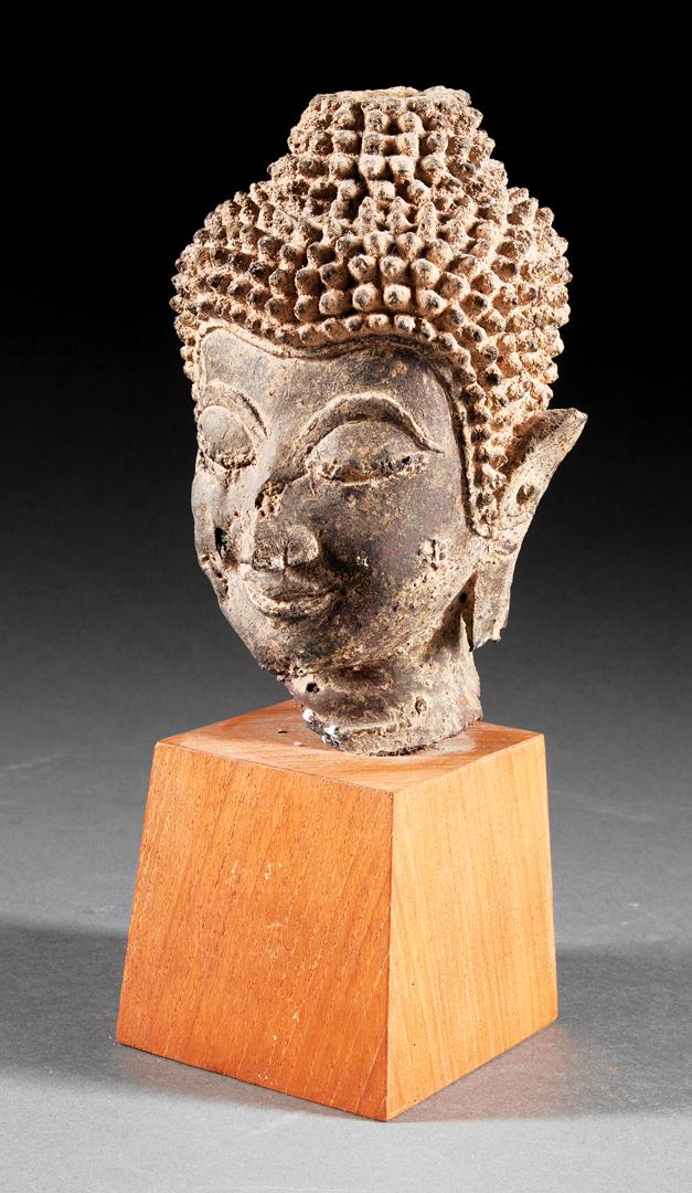 Antique Southeast Asian Bronze Buddhist Head: Antique Southeast Asian Bronze Buddhist Head , h. 6 1/4 in., mounted to a wood base, overall h. 9 3/4 in . Provenance: Acquired 1990s IMPORTANT: All purchases must be removed from our premises within 