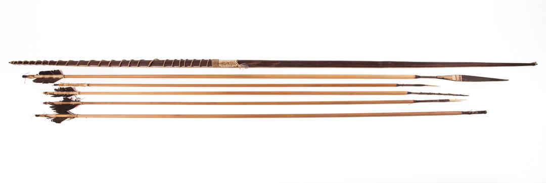 African Carved Wood, Feather, String Bow/Arrows: African Carved Wood, Bone, Feather and String Bow and Five Arrows , Pygmy, Zaire, Congo, bow, l. 84 1/2 in.; arrows, l. 74 1/2 in. to 57 1/2 in. Condition: surface dirt; bow: overall good condition, s