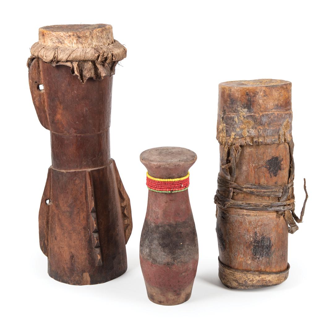 Three African Drums: Three African Drums , painted wood and bead embellished, h. 8 1/2 in., carved wood; h. 15 in.; and leather embellished wood, h. 11 5/8 in. Condition: bead embellished drum: wear to painted decoration;