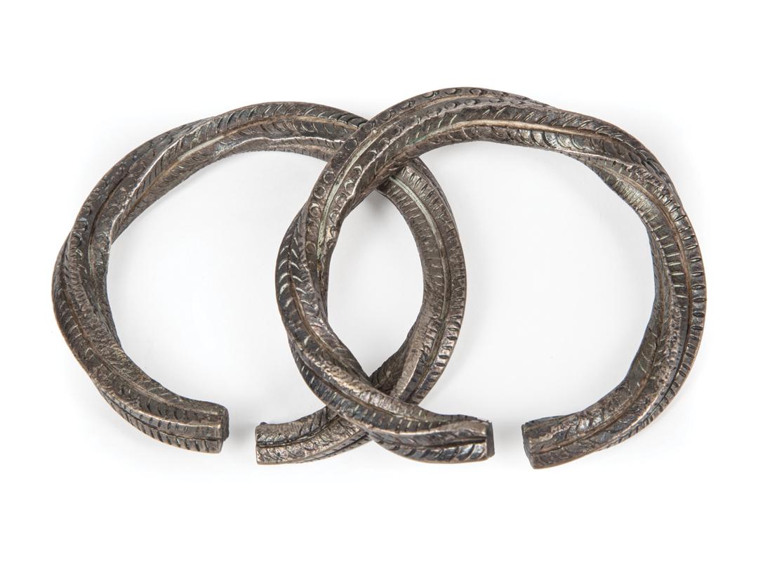 Two African Silver Bracelets: Two African Silver Bracelets , Cameroon, spiraled circle and dash motif, dia. 2 3/4 in. Condition: good Provenance: Property of the Mobile Museum of Art, Mobile, AL, sold to benefit their Collections,
