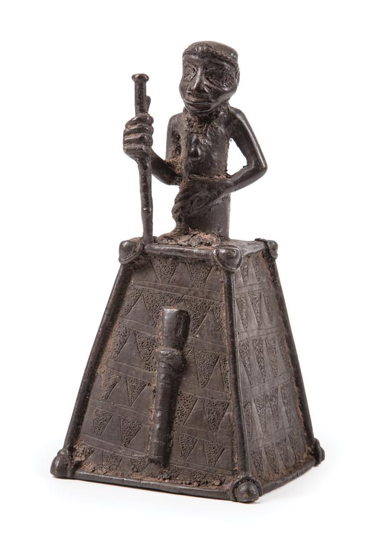 African Bronze Figural Altar Bell: African Bronze Figural Altar Bell , Benin, Nigeria, crowned male figure with staff, geometric incisions, h. 7 1/4 in., w. 3 1/2 in., d. 3 3/8 in. Condition: surface dirt; light scattered marks and scr