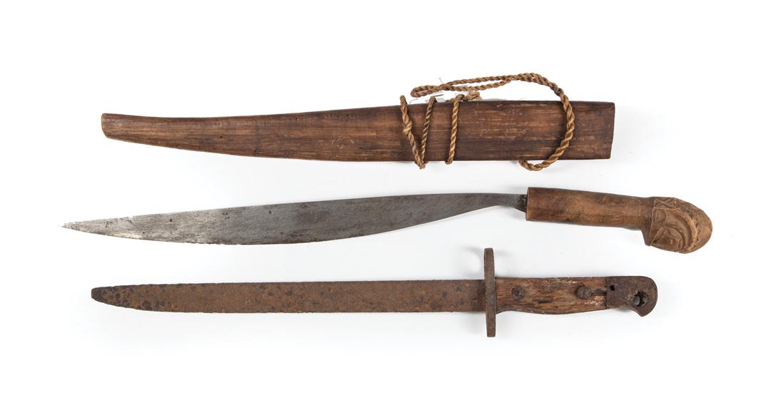 African Carved Wood Sword and Scabbard: African Carved Wood Sword and Scabbard , geometric carving to hilt, l. 20 1/4 in.; TOGETHER WITH bayonet, l. 16 1/4 in. Condition: scabbard is split and loose; heavy losses to wood handle of bayonet; 