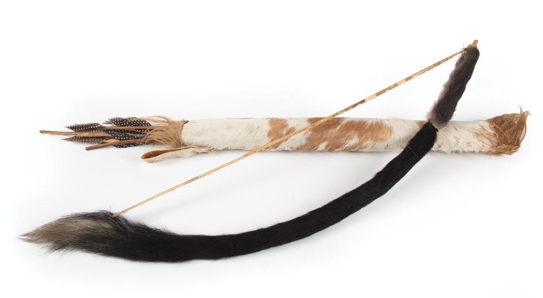 African Carved Wood Bow and Hide Quiver/ 7 Arrows: African Carved Wood Bow and Hide Quiver and Seven Arrows , fur embellished bow, l. 28 in.; hair embellished quiver, l. 21 3/4 in.; wooden tip arrows with feather fletching, l. 24 1/2 in. to 26 1/2 in.