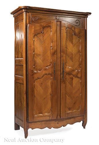 French Inlaid and Carved Chevron Paneled Armoire: Antique French Inlaid and Carved Chevron Paneled Armoire , 19th c., coved cornice with outset corners, scroll carved frieze, fiche hinges, spurred paneled doors, reeded center stile, shaped apron and 