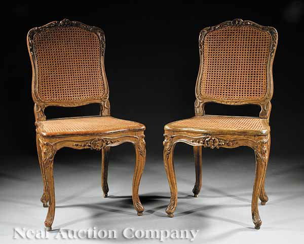 Pair of Louis XV Carved Beechwood Chaises: A Pair of Louis XV Carved Beechwood Chaises, 18th c., each with floral-carved scalloped crest, shaped molded stiles, serpentine rail, cabriole legs topped by anthemion cartouche, retaining original ca