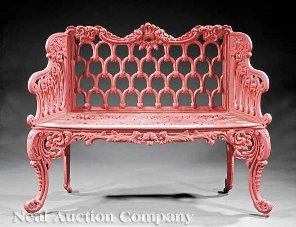 Pair of American Rococo Cast Iron Garden Settees: A Pair of American Rococo Cast Iron Garden Settees, mid-19th c., probably New York, after a design introduced by Carron Ironworks, Scotland (1759-1982), scalloped floral crest, the back of interlockin