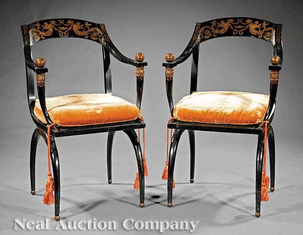 Pair Lacquered, Gilt-Decorated Curule Armchairs: A Pair of Italian Lacquered and Gilt-Decorated Curule Armchairs, early 20th c., in the style of Jean Joseph Chapuis (Brussels, 1765-1864), arched crests with lyre and putti, shaped arms terminating in