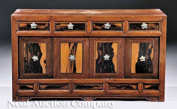 Korean Persimmonwood and Hardwood Low Cabinet: An Antique Korean Persimmonwood and Hardwood Low Cabinet, 19th c., with four short drawers over cabinet doors, paneled plinth, bracket feet, height 20 1/2 in., width 36 in., depth 14 1/4 in