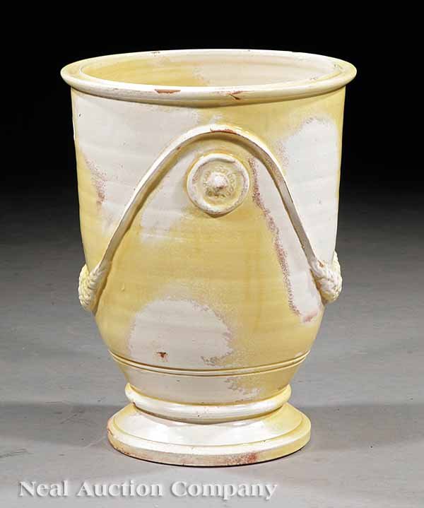 Tuscan Faience Urn: A Tuscan Faience Urn, pale yellow and creme glazes, applied swag and roundel decoration, height 16 1/4 in., diameter 13 in