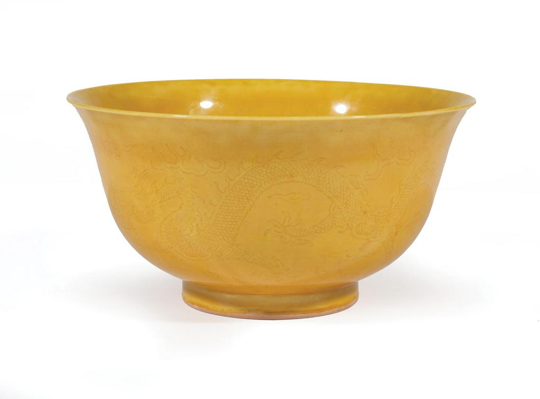 Chinese Yellow Glazed Porcelain Bowl: Chinese Yellow Glazed Porcelain Bowl , 20th c., incised with confronting dragons amid flaming clouds, base with Chenghua mark, h. 3 1/4 in., dia. 6 1/2 in Provenance: Estate of Julia Evans Reed