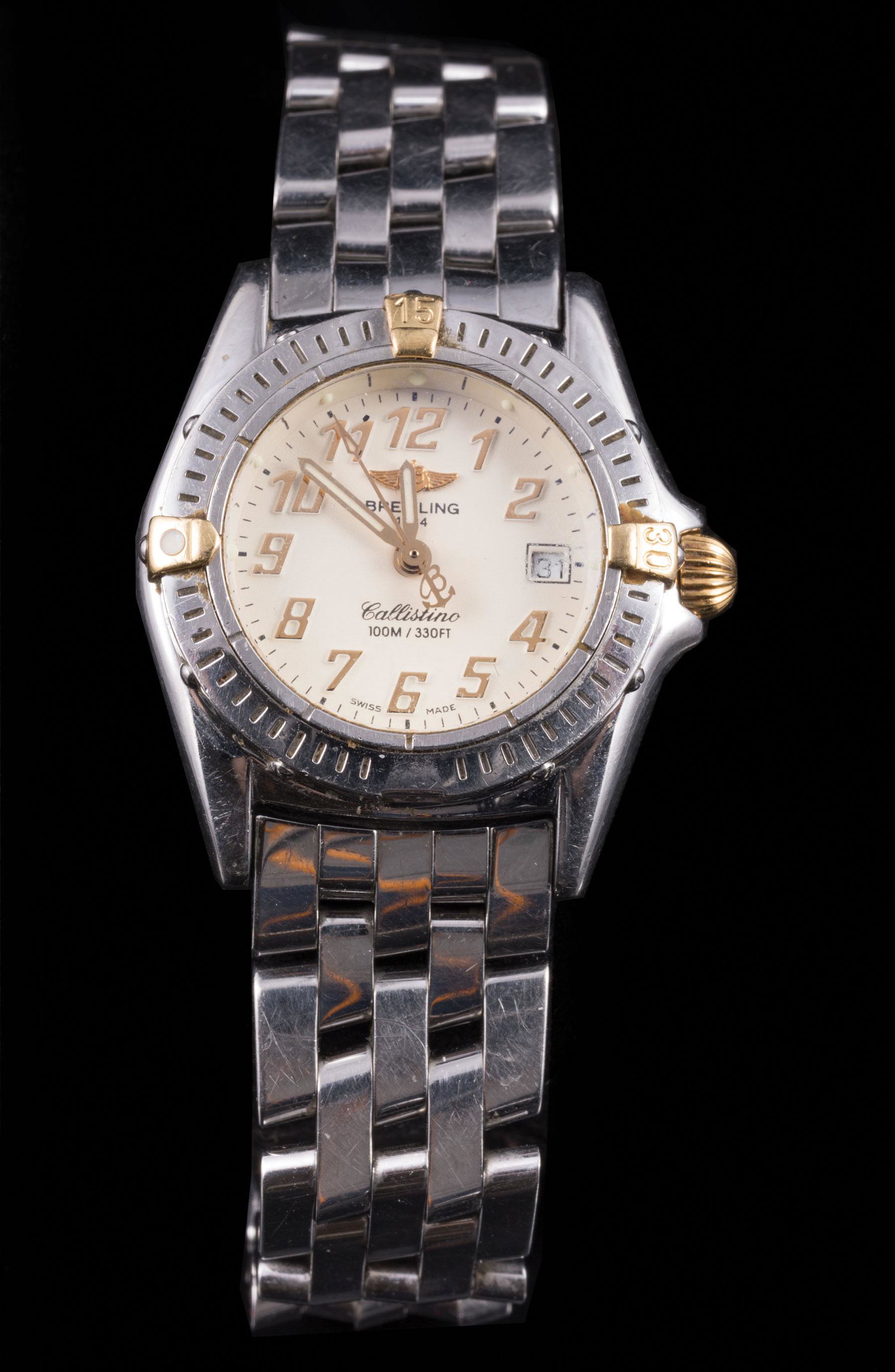 Breitling Stainless Steel and 18 kt. Gold Watch: Breitling Stainless Steel and 18 kt. Gold "Callistino" Lady's Wristwatch , quartz, cream dial, date aperture, rotating bezel with 18 kt. gold rider tabs, case numbered B52345, case dia. 28 mm, note: 1