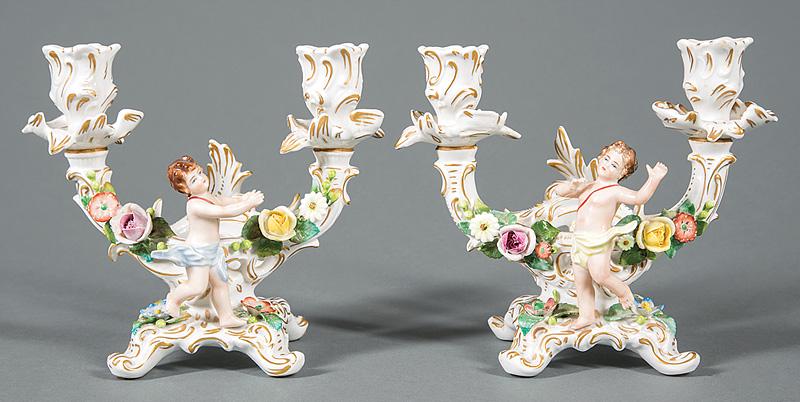 Sitzendorf Porcelain Two-Light Candelabra: Pair of Sitzendorf Polychrome and Gilt Porcelain Two-Light Candelabra , c. 1902-18, crown over crossed S mark, applied cherub and floral sprays, h. 7 1/2 in., w. 7 3/4 in., d. 4 in