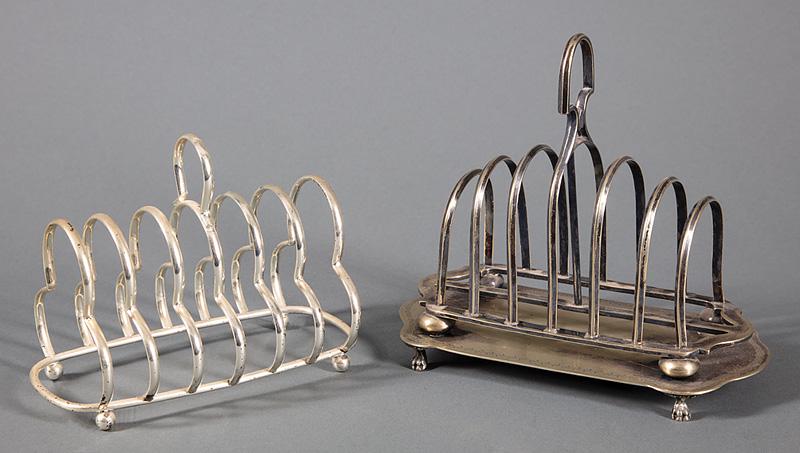 Two English Silverplate Toast Racks: Two English Silverplate Toast Racks , center handles, one mounted on a paw foot stand, h. 6 3/4 in., w. 7 3/4 in., d. 4 in.; other h. 5 1/2 in., w. 6 5/8 in., d. 3 1/2 in. Condition: Surface dirt and