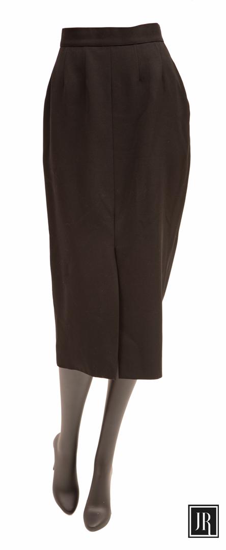 Chanel Black Wool Pencil Skirt: Chanel Black Wool Pencil Skirt , c. 1990, silk-lined, tag marked "Made in France", "OF N°: 01089" and "Style/Modele: 255/I11 60PA19229", gold logo button, size 44 Provenance: Estate of Julia Evans Re