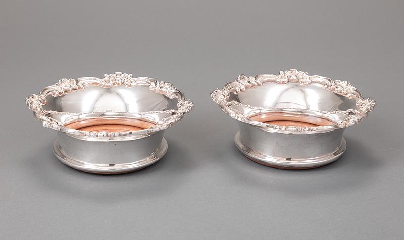 Pair of Silverplate Wine Coasters: Pair of Silverplate Wine Coasters , marked "ROYAL CASTLE/ SHEFFIELD/ EP", shell and scroll border, turned hardwood bottoms with silverplate button, dia. 7 1/8 in