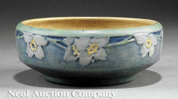Newcomb College Art Pottery Matte Glaze Bowl: A Newcomb College Art Pottery Matte Glaze Bowl, 1917, decorated by Sadie Irvine, relief-carved mock orange blossom motif, in blue, green and yellow underglaze, the base marked with Newcomb cipher, dec