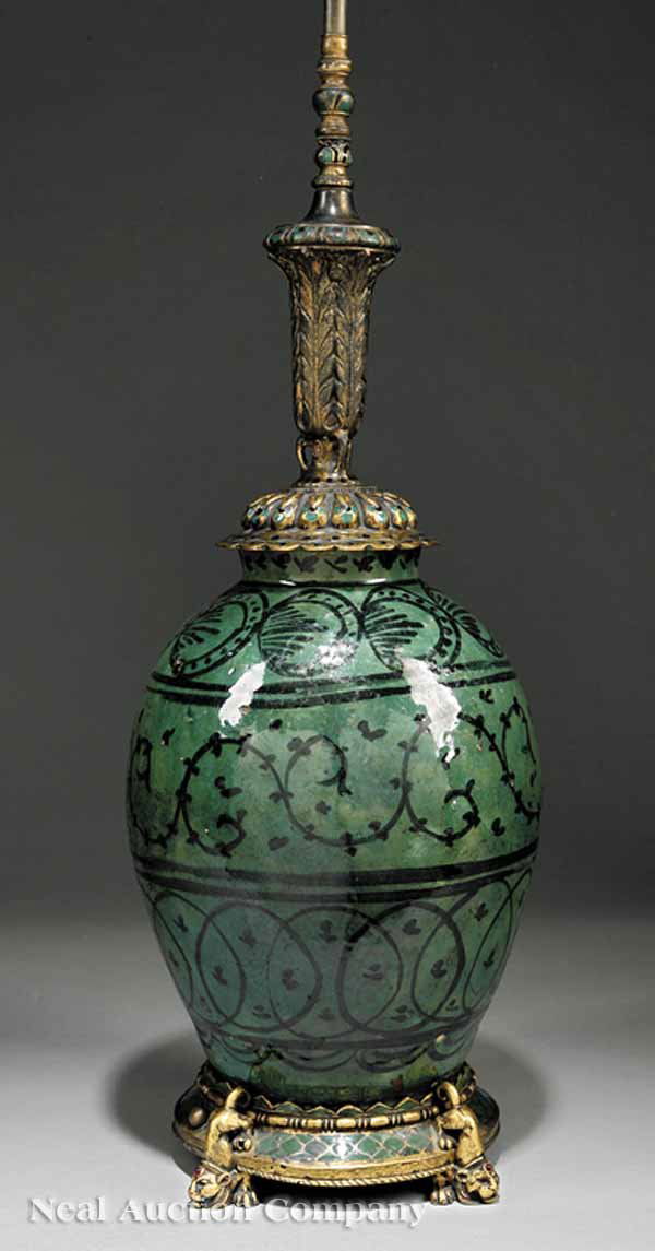 Persian Gilt Bronze-Mounted Earthenware Lamp: An Antique Persian Gilt Bronze-Mounted Earthenware Table Lamp, the earthenware body covered overall in a rich green glaze over black scrolling horizontal banding, the mounts with champleve enamel and