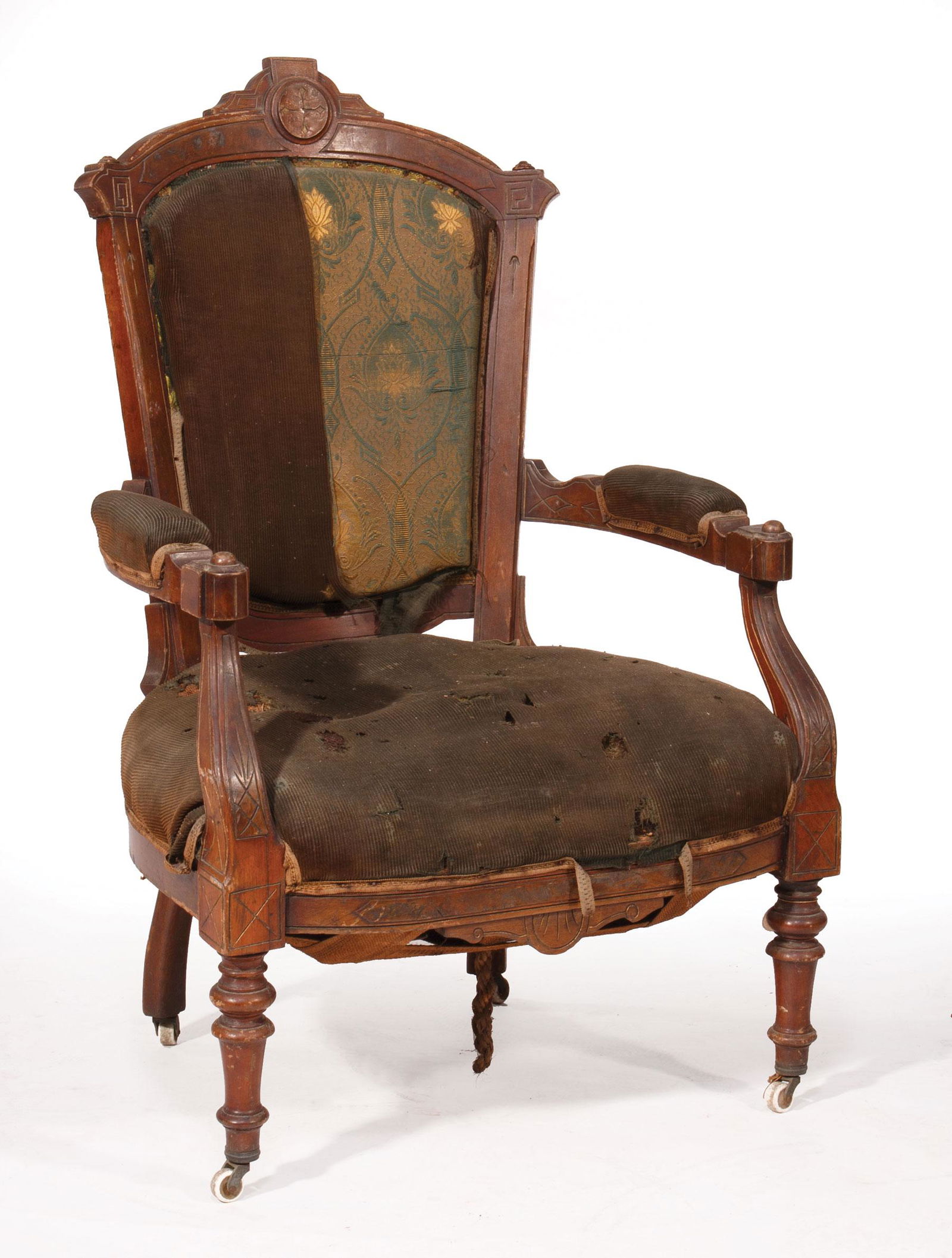 AmericanCarved Walnut Armchair: American Renaissance Carved Walnut Upholstered Armchair , mid-to-late 19th c., architectonic crest, shield back, padded arms, incised frame, trumpet feet, h. 41 3/4 in., w. 26 in., d. 24 in Provenance