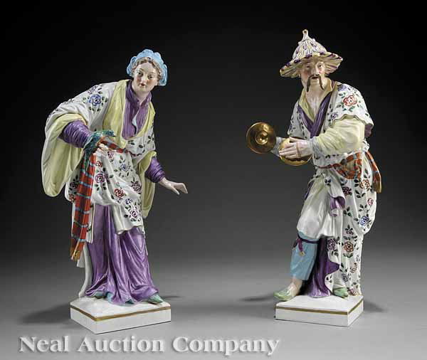 Pair of KPM Figures of a Gypsy Woman and Malabar: A Pair of KPM Porcelain Figures of a Gypsy Woman and Malabar, 19th c., each with underglaze blue torch, one with impressed "U", height 15 7/8 in. and 14 3/8 in. respectively. Note: Restoration to base