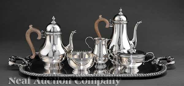 A Gorham Silver Six Piece Tea and Coffee Service: A Gorham Sterling Silver Six Piece Tea and Coffee Service in the Colonial Taste, comprising a tea pot, coffee pot, creamer, lided sugar and waste bowl with a silverplate tea tray, coffee pot height 9