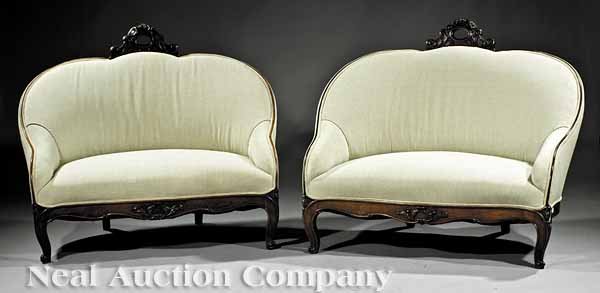 Pair of American Rococo Rosewood Slipper Settees: A Pair of American Rococo Carved Rosewood Slipper Settees, mid-19th c., floral-carved and scrolled crest rails, rounded backs, serpentine leaf-carved seat rails, cabriole legs, scrolled toes, height 3