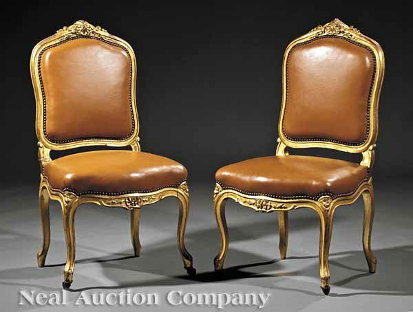 A Pair of Antique Louis XV-Style Chaises: A Pair of Antique Louis XV-Style Carved and Gilded Chaises, 19th c., each with a shell-carved serpentine seat rail, crest and stiles, floral-carved cabriole legs, casters