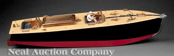 Orkin Craft Mechanical Toy Speedboat: An American Vintage Mechanical Toy Speedboat, 1923, by Orkin Craft, Beverly Hills, CA, painted wood construction mounted with gilt metal hardware, the cockpit with scale driver and working compass, ke
