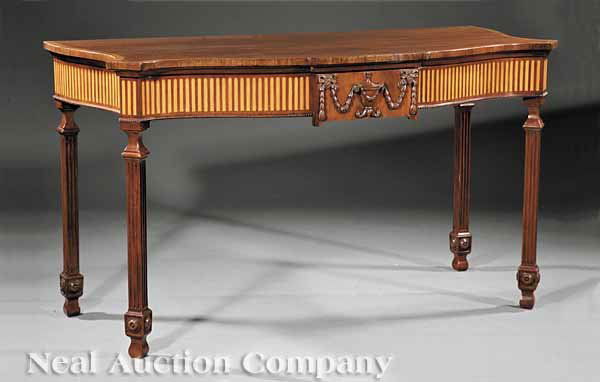 George III-Style Inlaid Mahogany Serving Table: A George III-Style Inlaid Mahogany Serving Table, serpentine top, blocked center drawer with urn and husk swags, the beaded skirt with satinwood inlaid flutes, raised on blocked and fluted square legs
