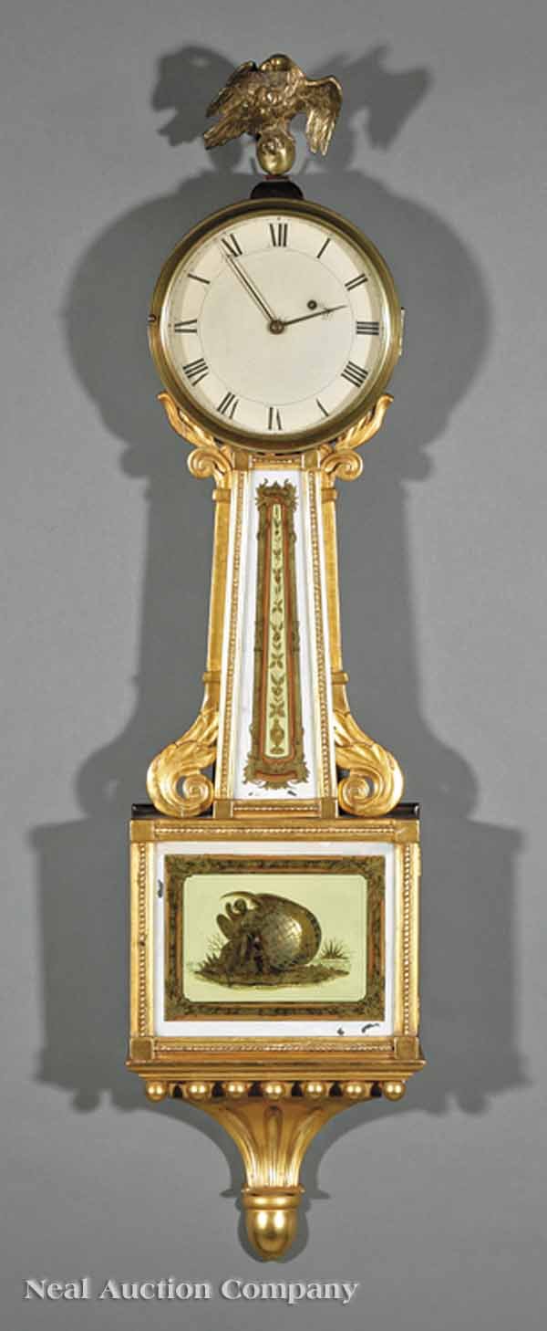 Aaron Willard Jr. Giltwood, Eglomise Banjo Clock: A Federal Carved Giltwood and Eglomise Banjo Clock, Aaron Willard Jr., c. 1820, signed on tablet and movement, eagle finial, painted dial, glass tablets decorated with vining urns and representation o