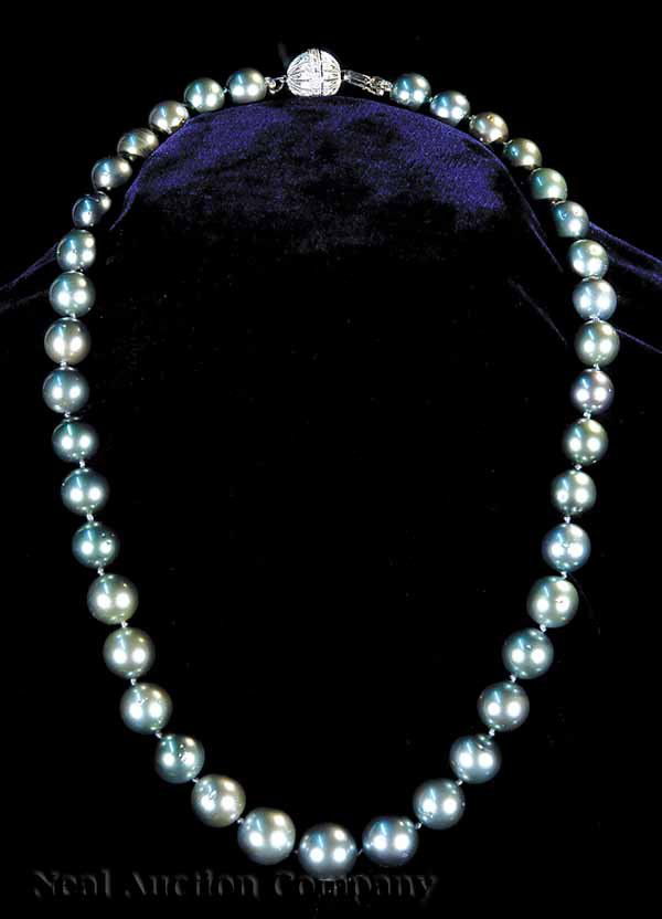 Black Tahitian South Sea Pearl Necklace: A Black Tahitian South Sea Pearl Necklace, containing 39 natural pearls graduated from 10 to 13 mm., with an 18 kt. white gold and diamond ball clasp, length 18 1/2 in