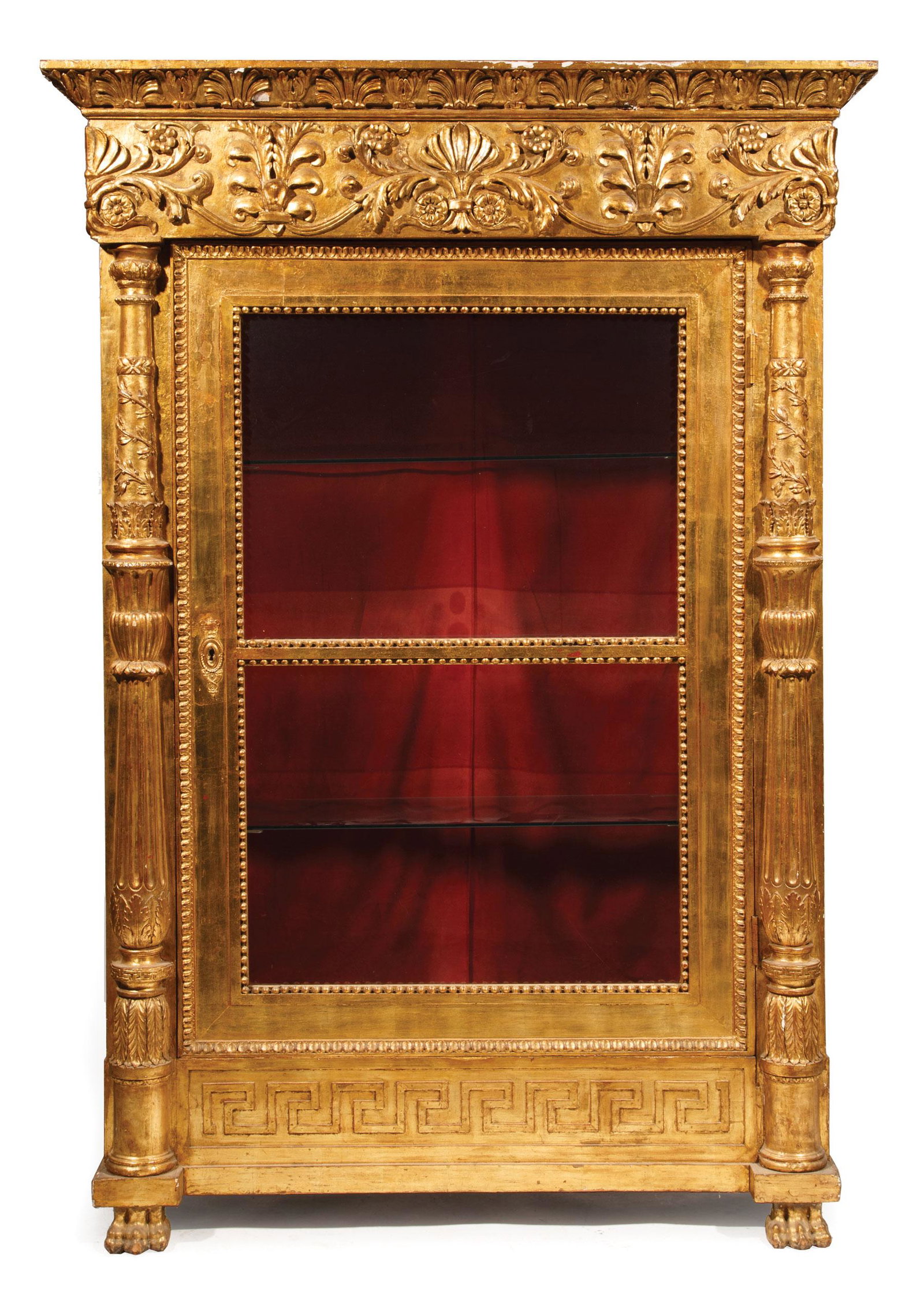 Carved and Gilt Vitrine Cabinet: Monumental Carved and Gilt Vitrine Cabinet , anthemion cornice and frieze, acanthus carved pilaster, beaded glazed doors, glass shelf interior, Greek key base, paw feet, h. 98 in., w. 68 in., d. 25 in